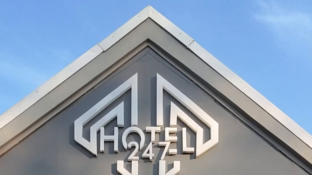 The Hotel 247 White River sign on the gable of the hotel